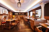 a restaurant with wooden tables and chairs in a room at Hotel Prinzregent München Messe in Munich