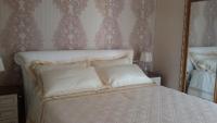 A bed or beds in a room at Daphnae House