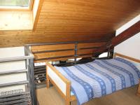 a bunk bed in a room with a wooden ceiling at Villa Jules in Chamonix