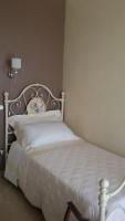 A bed or beds in a room at Daphnae House