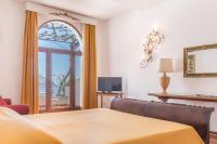 a living room with a table and a window at Hotel Poseidon in Positano