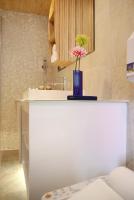 a white counter with a vase with a flower on it at Homey House in Taipei