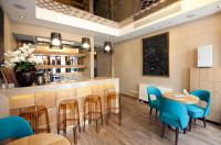 a restaurant with a bar with blue chairs and tables at Collage Taksim Hotel in Istanbul