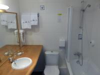 a bathroom with a toilet and a sink and a shower at Hotel Le Marin in Auray