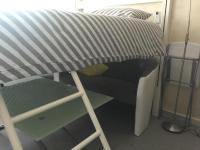 a bed and a chair in a small room at Fréjus Studio in Fréjus