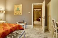 A bed or beds in a room at L'Agora Old Town Hotel & Bazaar