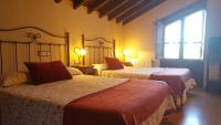 Hotel Rural Casa Cuetoにあるベッド