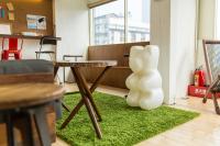 a white sculpture sitting on a green rug in a room at Mr. Lobster’s Secret Den design hostel in Taipei