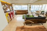 a living room with a couch and tables and chairs at Mr. Lobster’s Secret Den design hostel in Taipei