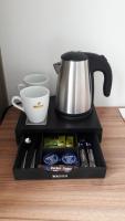 a coffee pot and a cup on a table at Hotel Garden Court in Prague