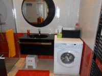 a bathroom with a washing machine and a mirror at Gite du Cret in Hotonnes