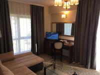 a living room with a couch and a desk with a computer at Hotel Arnia in Iaşi