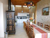 a kitchen and dining room with a table and a stove at Gite du Cret in Hotonnes