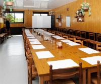 a long wooden table in a large room with chairs at Hotel Restaurant Maurice in Châteauroux