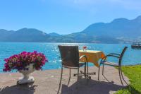a table and two chairs and a table and a vase with flowers at Hotel Stadler am Attersee in Unterach am Attersee