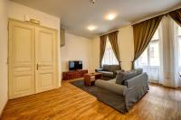 a living room with a couch and a tv at Residence St Havel Prague Old Town in Prague