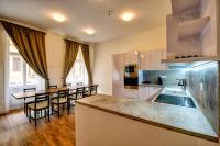 a kitchen with a table and chairs in a kitchen at Residence St Havel Prague Old Town in Prague