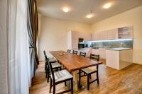 a dining room with a table and chairs and a kitchen at Residence St Havel Prague Old Town in Prague