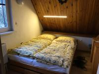 A bed or beds in a room at Chata Lucia