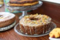 a table with different types of cakes on plates at Pousada Casa do Catavento in Búzios