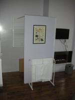 a white room with a chair and a television at Chambres d&#39;Hôtes Villa Bellevue in Albi