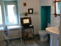 a bathroom with a toilet and a sink and a mirror at Chambres d&#39;hôtes la Graineterie in Buxy