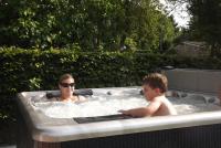 a woman and a child in a hot tub at B&amp;B La Buissonniere in Xhoris