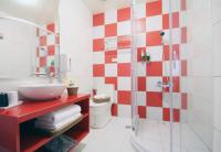 a bathroom with a red and white checkered wall at Bei Yue B&amp;B in Luodong