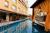 a swimming pool in front of a building at The Loft Seaside Suites in Jinshan