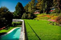 a bridge over a river in a grassy field at Hotel Antumalal in Pucón