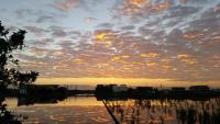 a sunset over a body of water with clouds at Yilan Xiang Feng Homestay in Wujie