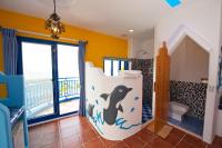 a bathroom with a dolphin themed toilet and a balcony at Haisu Homestay in Eluan