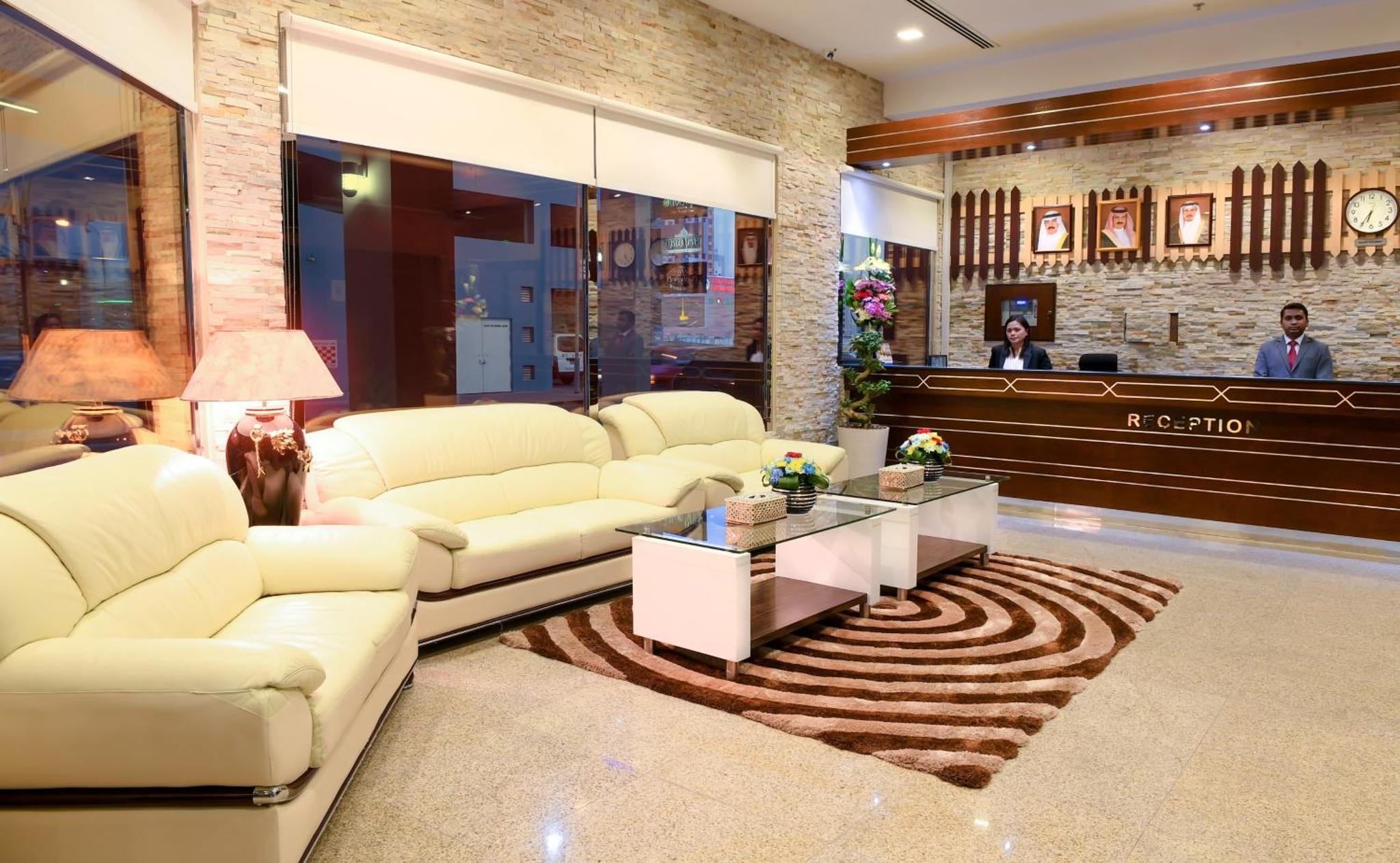 a living room with white couches and a table at Montana Tower in Manama +15 photos