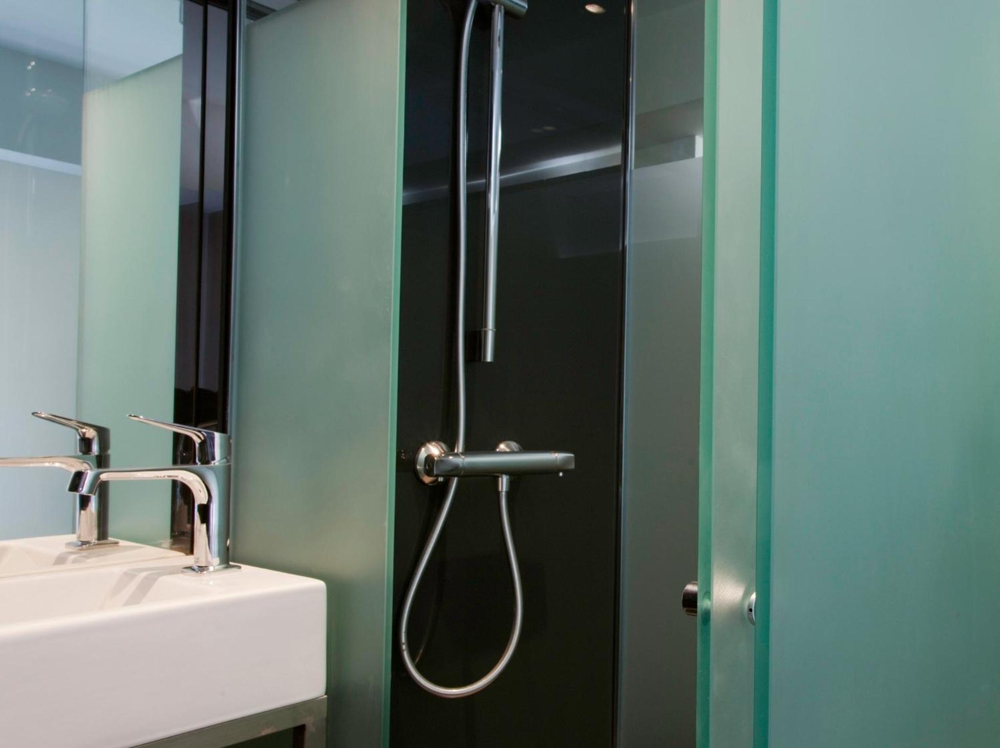 a bathroom with a shower and a sink at The Z Hotel Soho in London