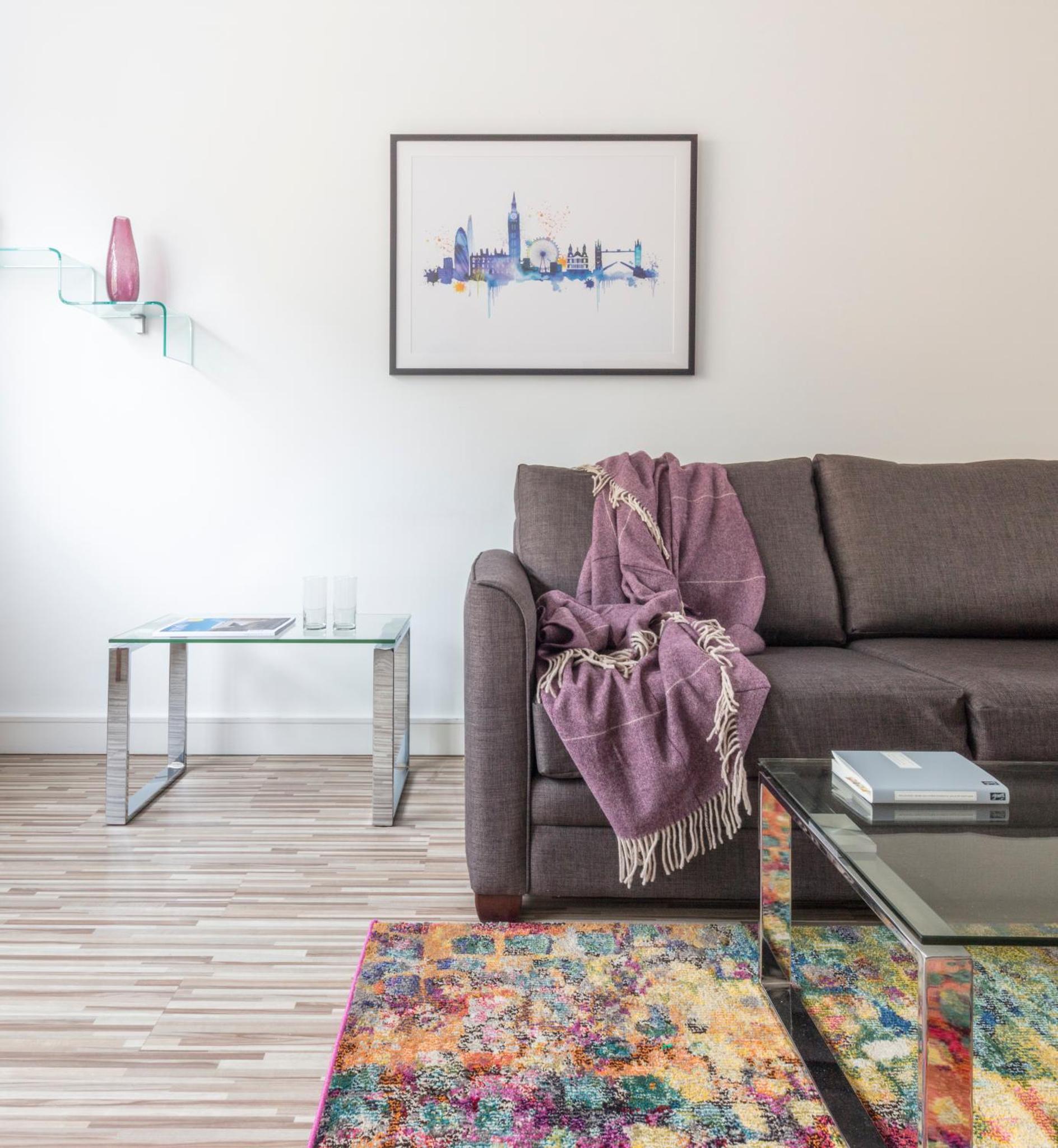 a living room with a couch and a table at SACO Holborn – Lamb’s Conduit St in London