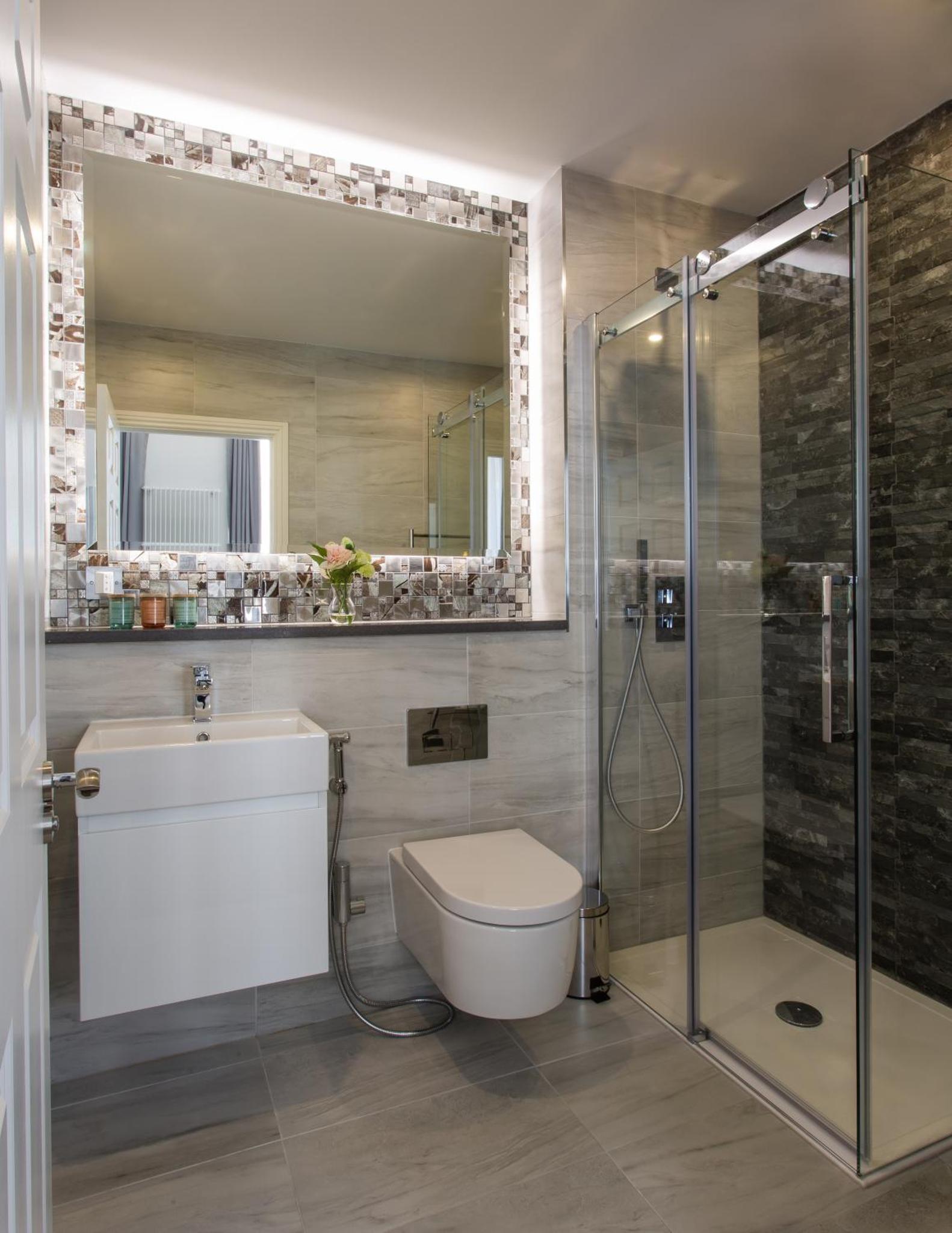 a bathroom with a shower and a toilet and a sink at Baker Street by Viridian Apartments in London +42 photos