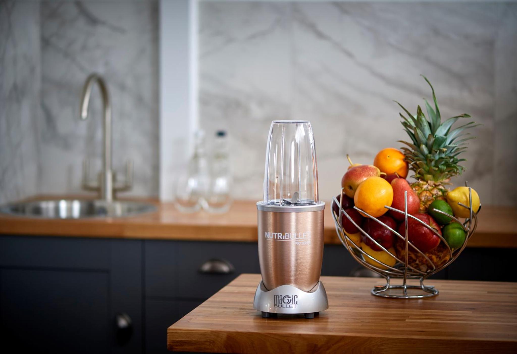 a blender sitting on a table with a bowl of fruit at The Lodge Hotel - Putney in London