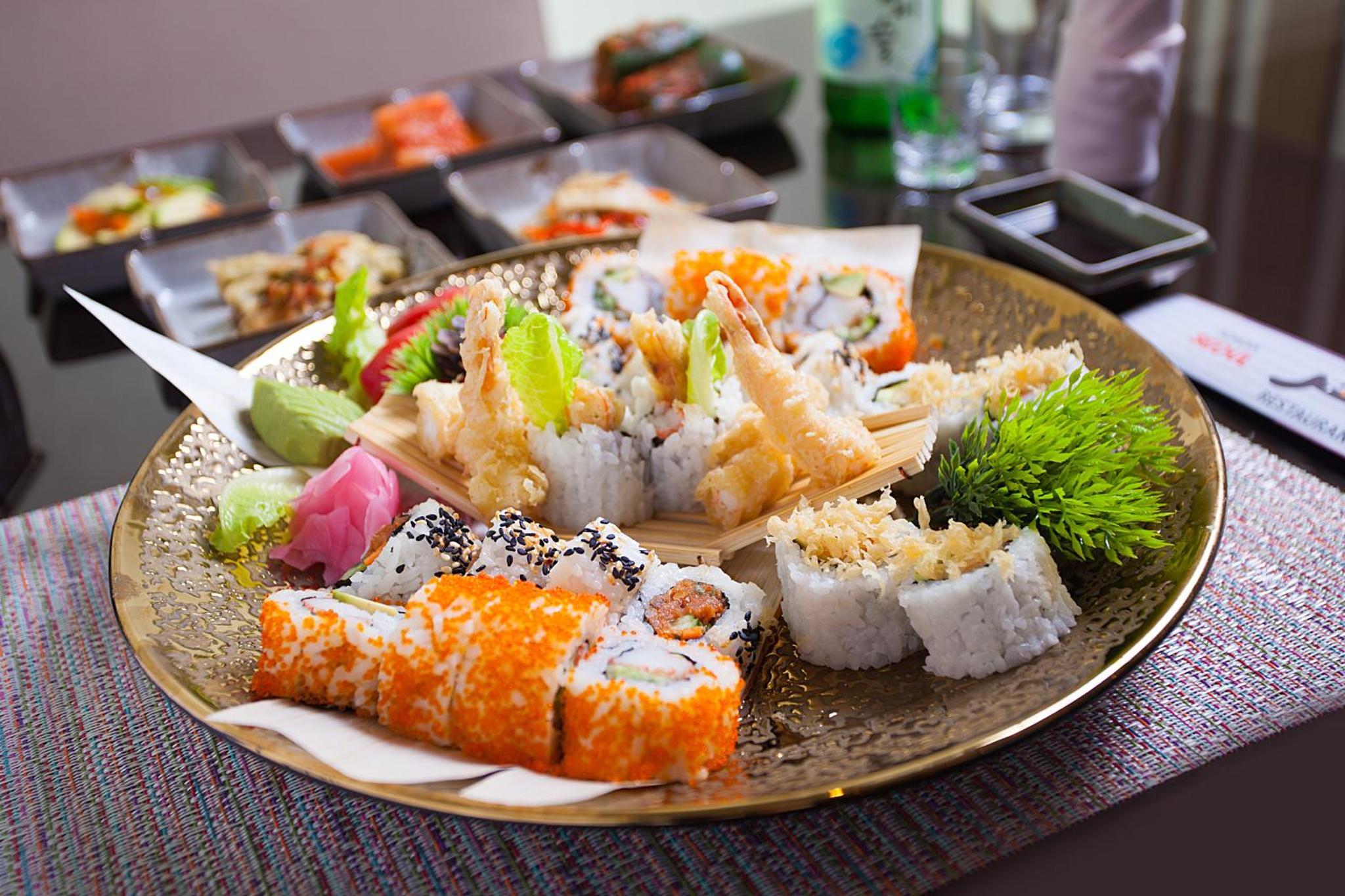a plate filled with sushi on top of a table at Asdal Boutique Hotel Seef in Manama +83 photos