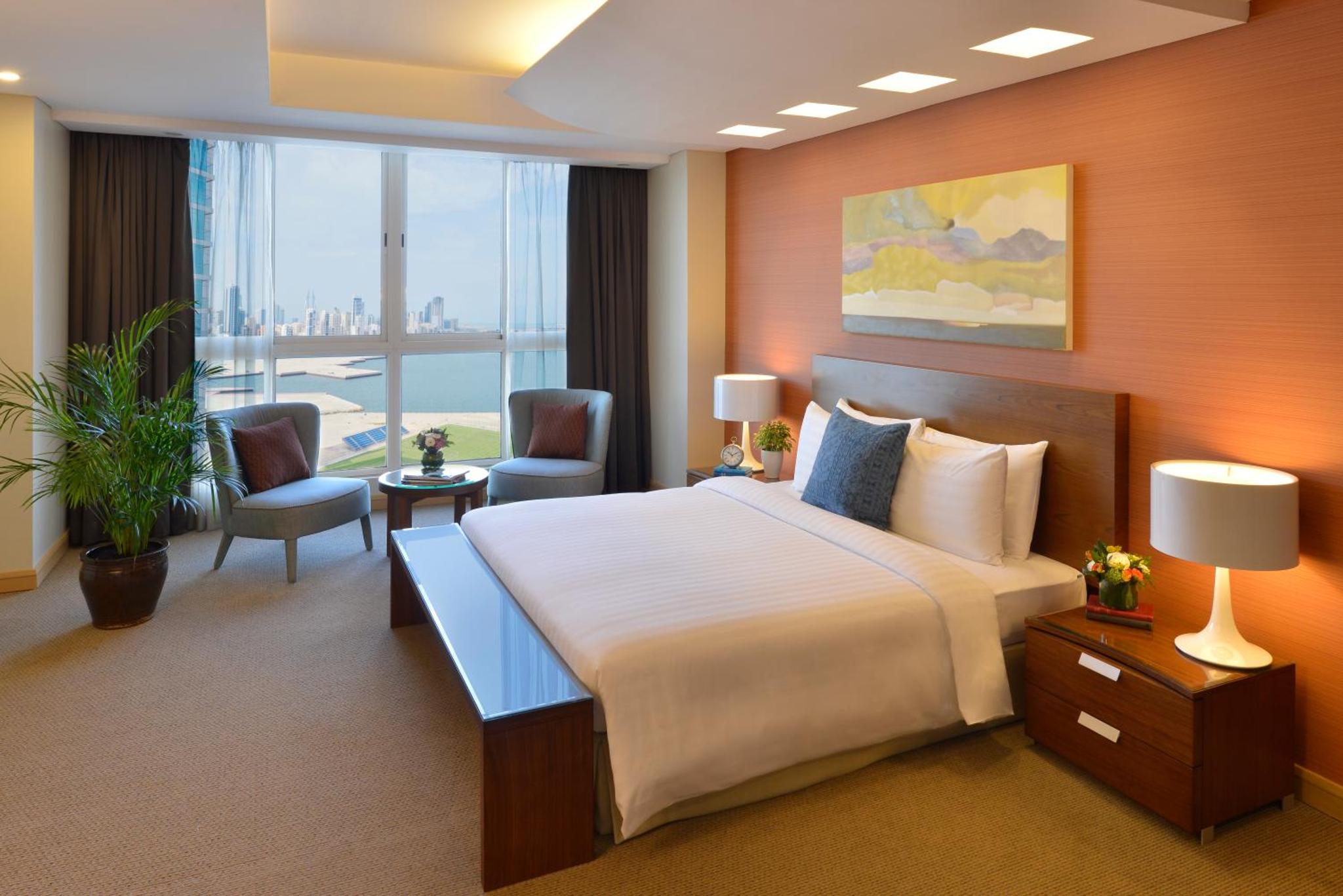 a hotel room with a bed and a large window at Mysk Al Fateh Bahrain in Manama +41 photos