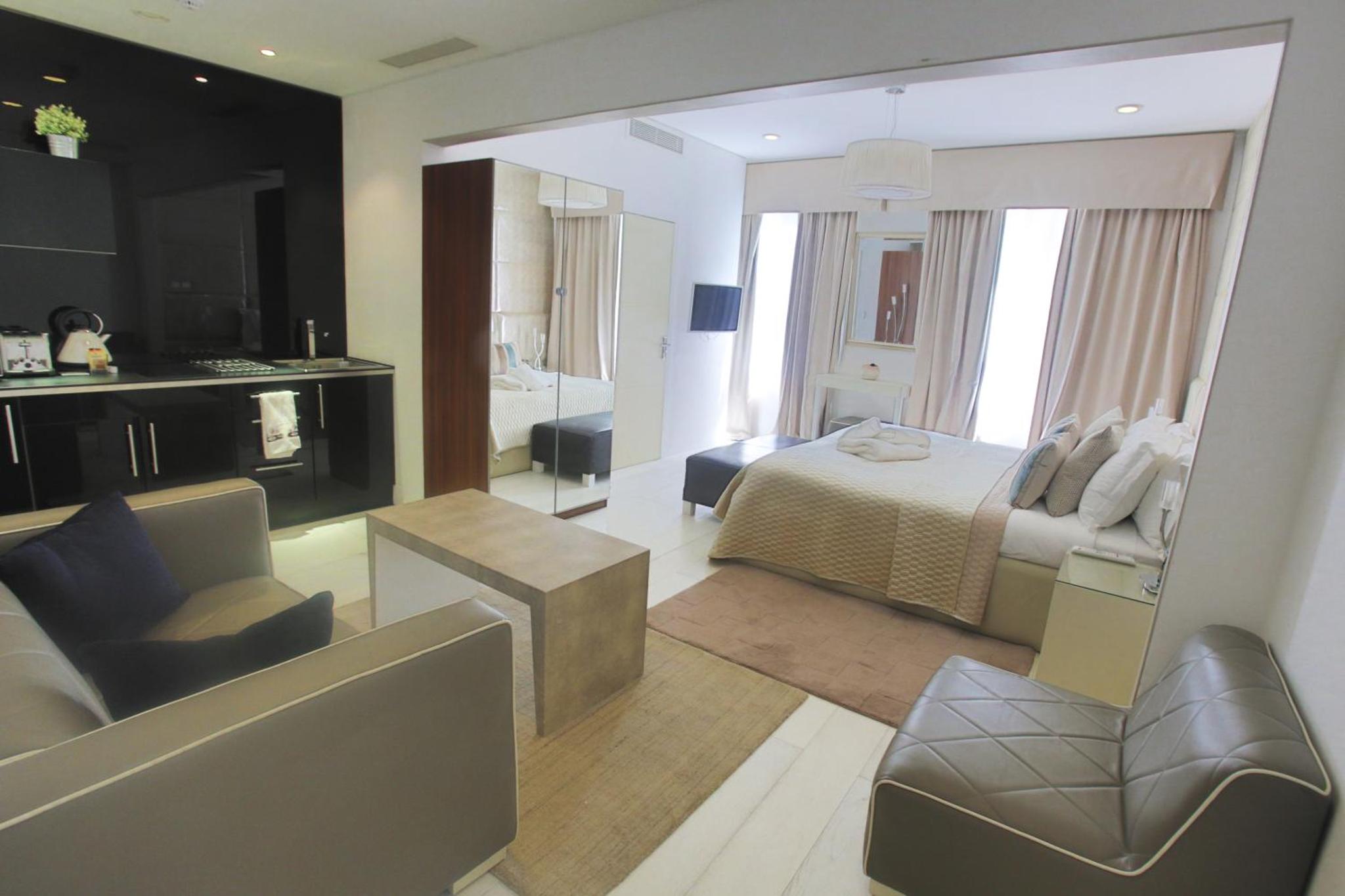 a bedroom with a bed and a living room at Room Home Stay in London