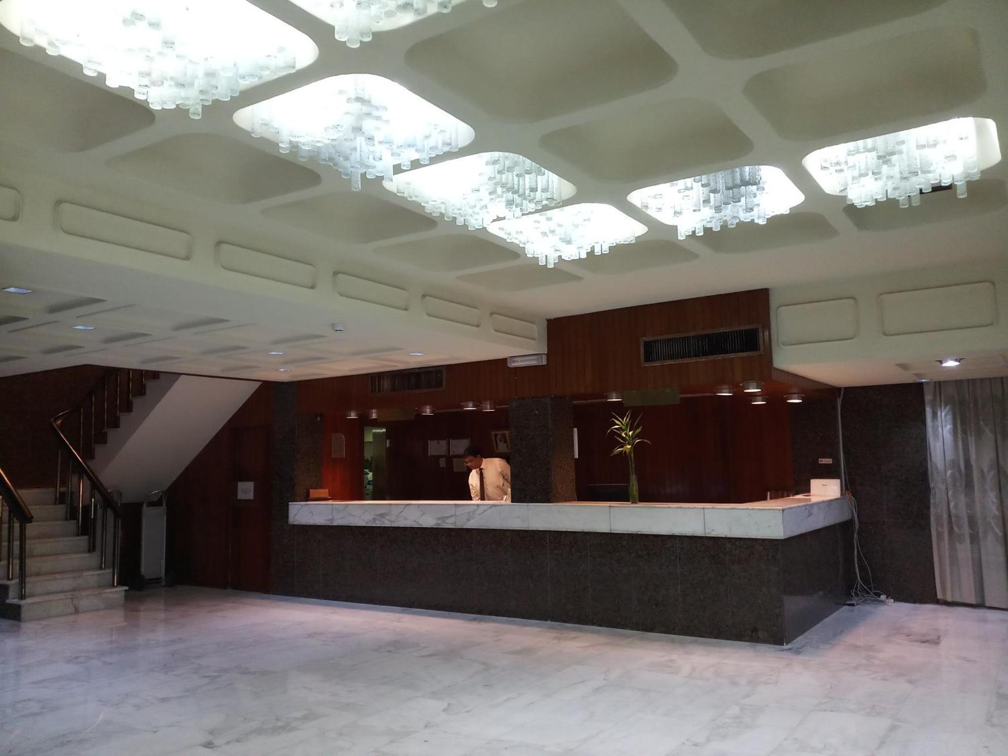 a building with a lobby with lights on the ceiling at Oriental Palace Hotel in Manama