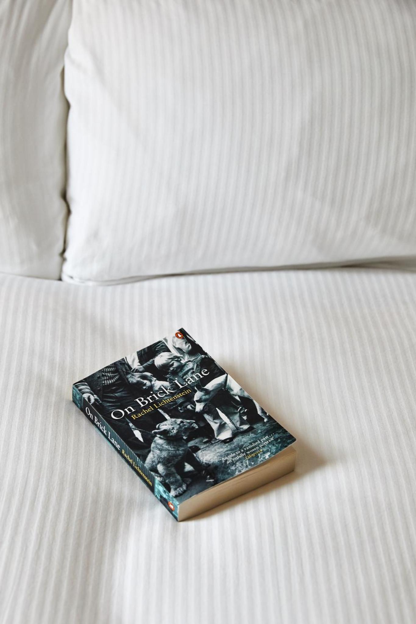 a book sitting on top of a bed at The Buxton in London +15 photos