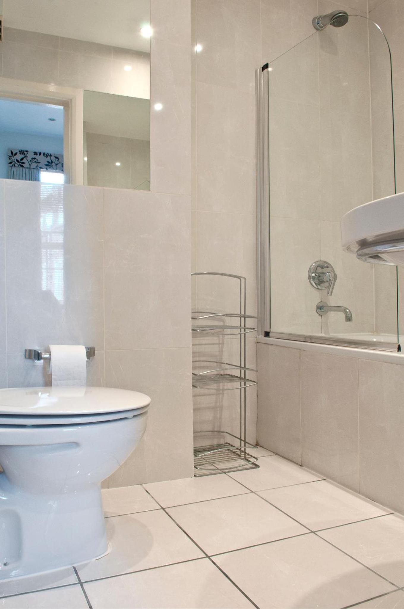 a bathroom with a toilet and a shower at Rushmore Hotel in London +47 photos
