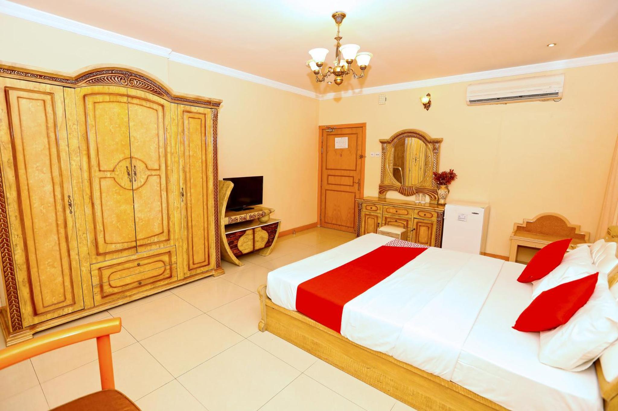 a bedroom with a large bed and a television at Sea Shell Hotel in Manama +88 photos