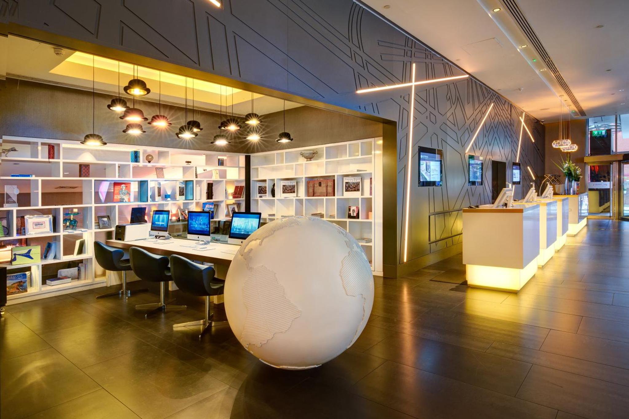 a large room with a table with two laptops on it at Pullman London St Pancras in London