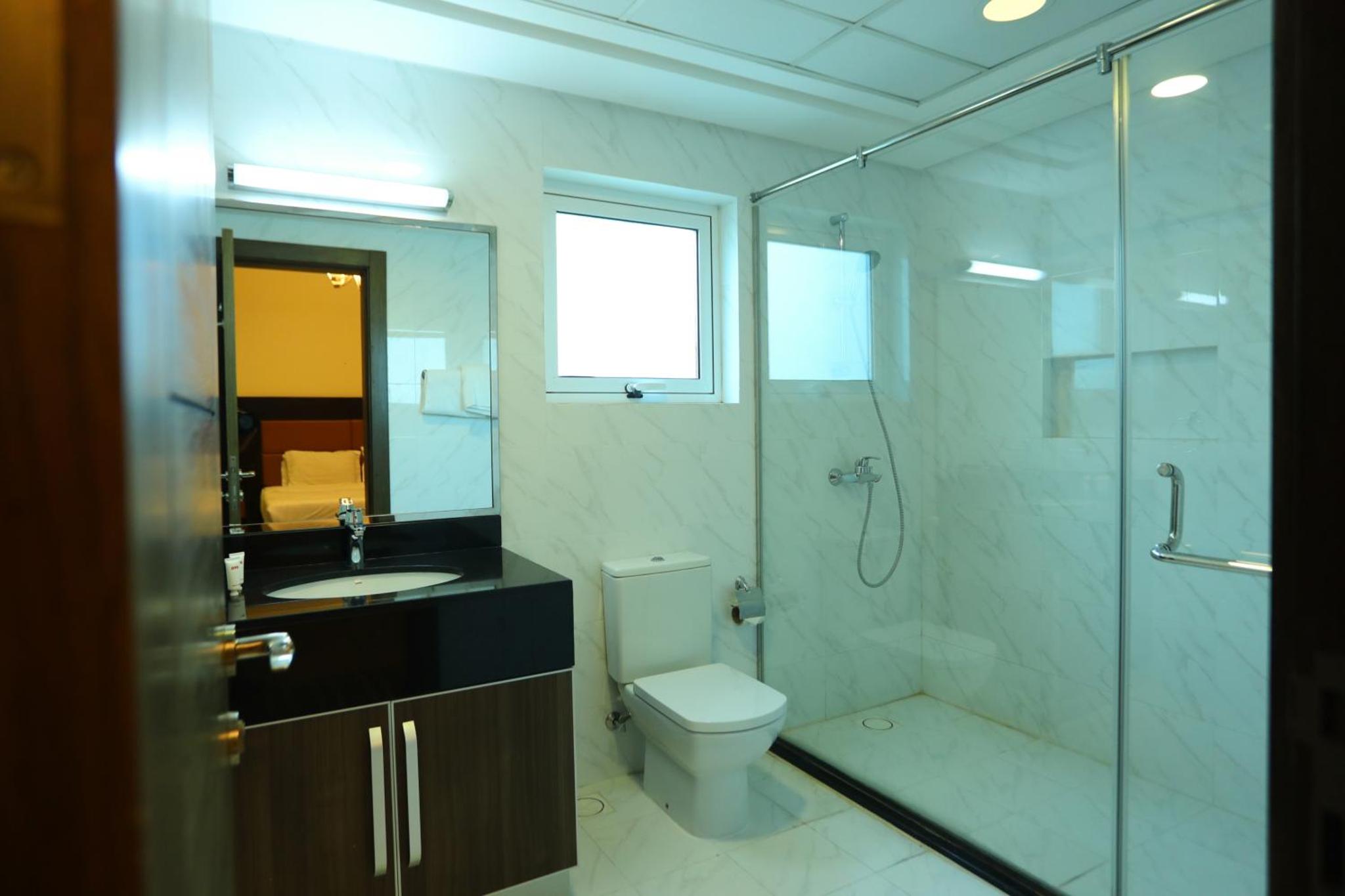 a bathroom with a toilet sink and a shower at Ginger Luxury House in Juffair +15 photos
