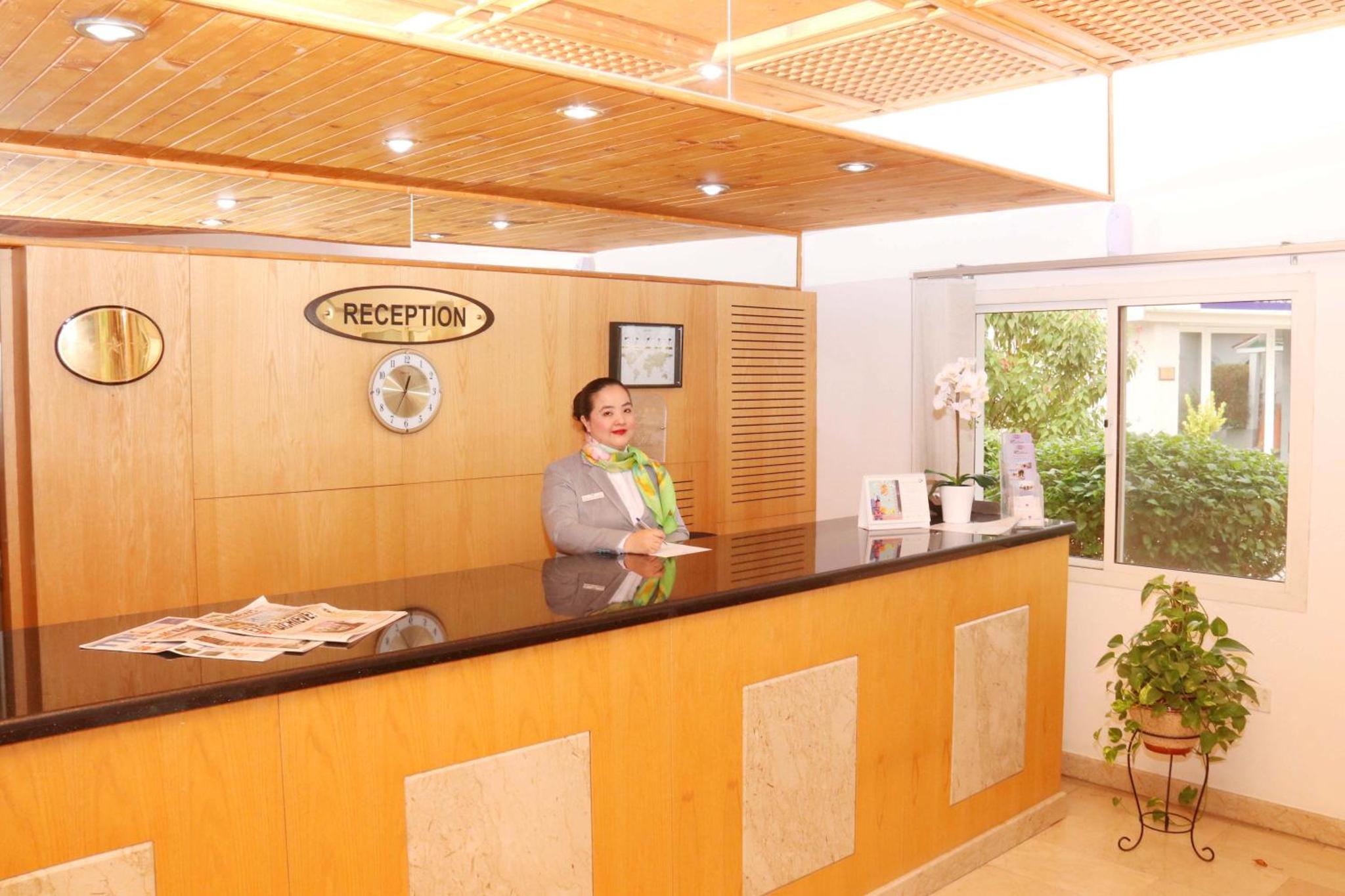 a man standing at a reception desk in a room at Tropicana Hotel in Manama +64 photos