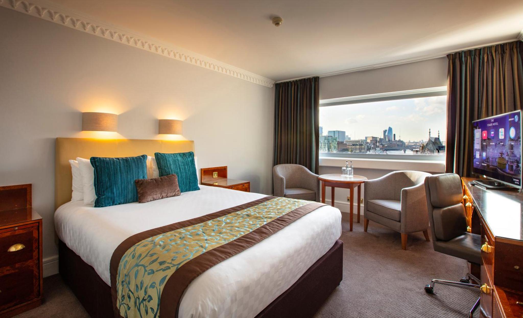 a hotel room with a large bed and a window at The Tower Hotel, by Thistle in London