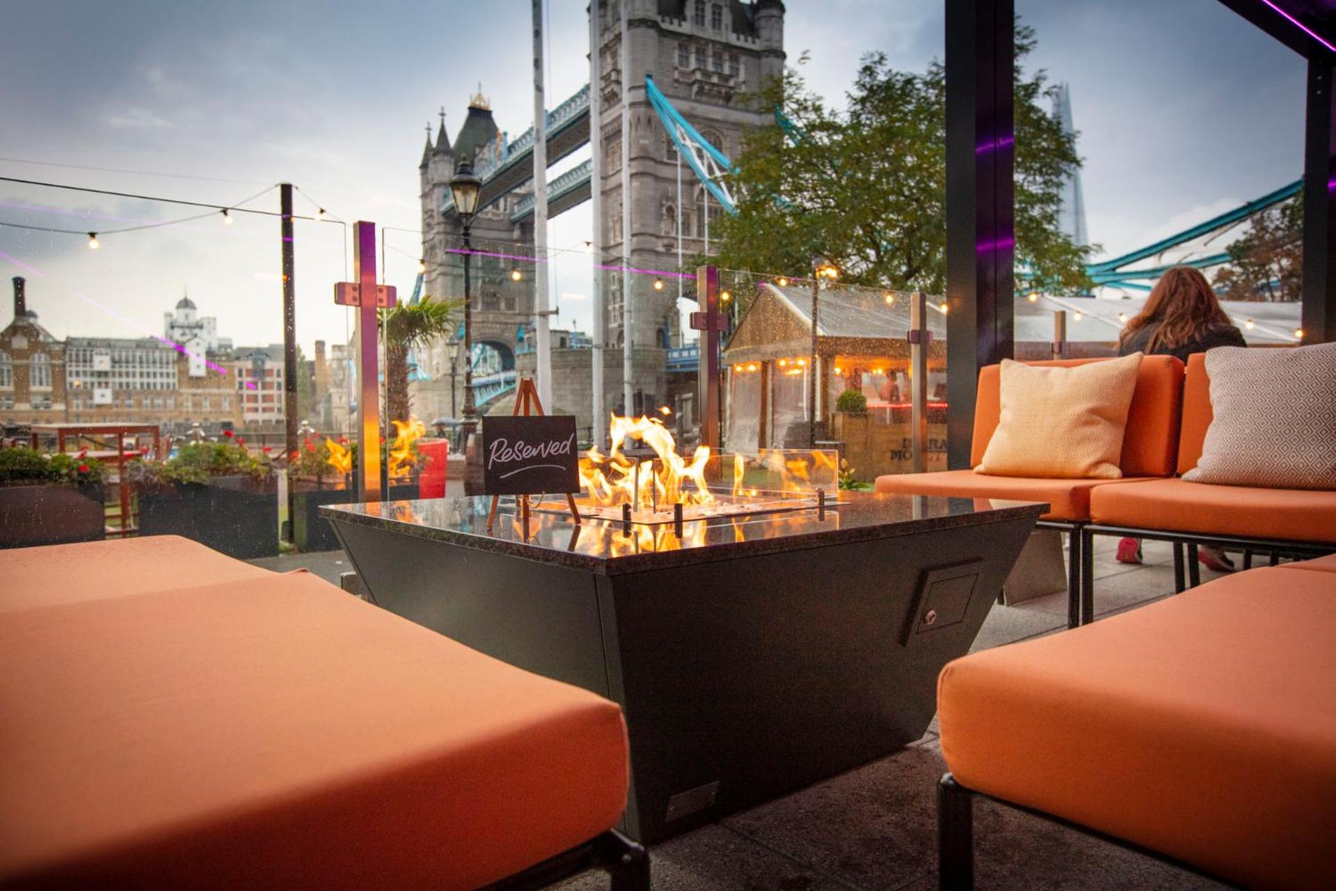 a cafe with a fountain in the middle of a city at The Tower Hotel, by Thistle in London