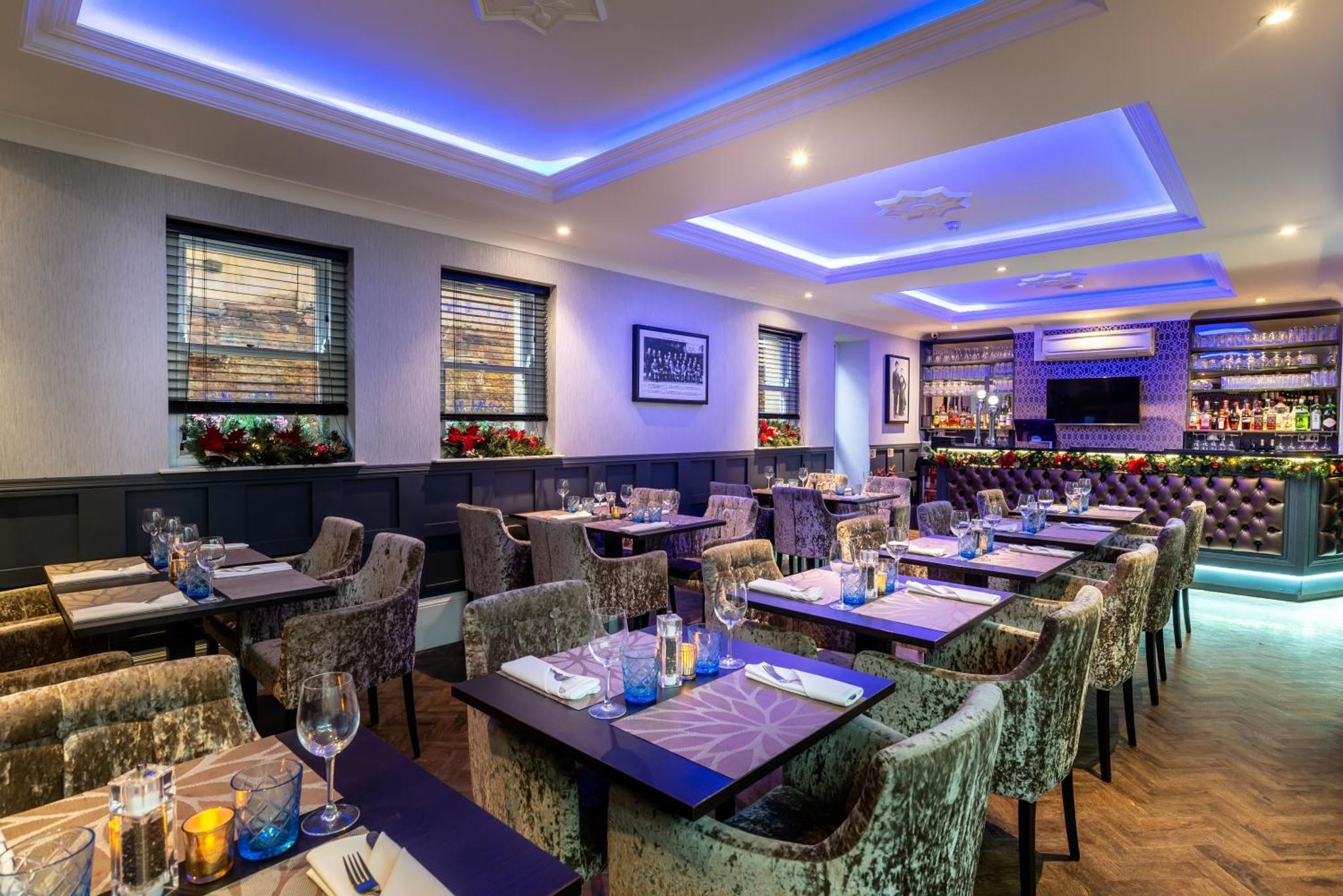 a restaurant with tables and chairs and a bar at The Lansbury Heritage Hotel and Spa By Sunday - Canary Wharf London in London